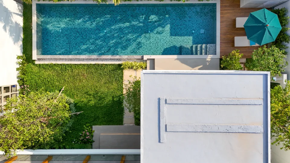 Overhead view of the pool, lawn and a terrace umbrella